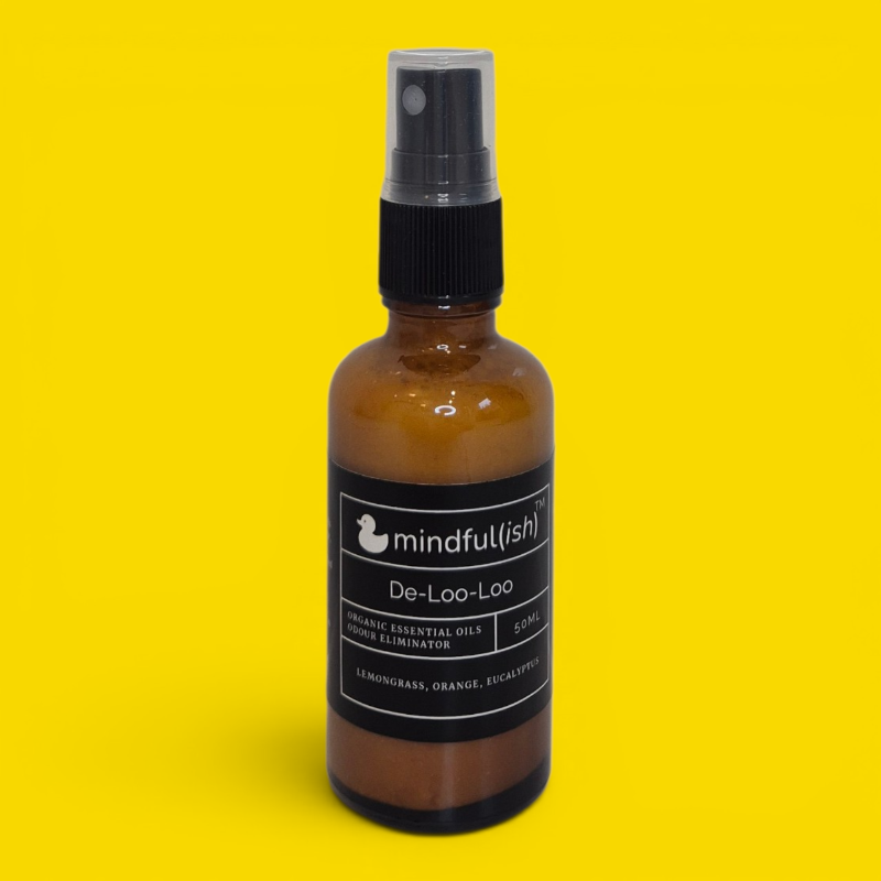 De-Loo-Loo organic bathroom spray — amber glass bottle with lemongrass, orange, and eucalyptus essential oils
