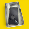Phone jail tin open with a smartphone locked inside — the mindful sh*t Kit digital detox tool