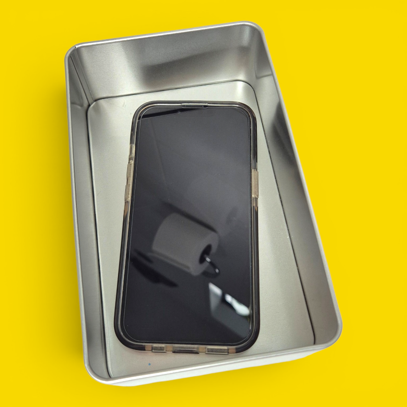 Phone jail tin open with a smartphone locked inside — the mindful sh*t Kit digital detox tool